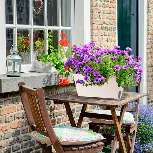 Green self-watering planter with fresh herbs