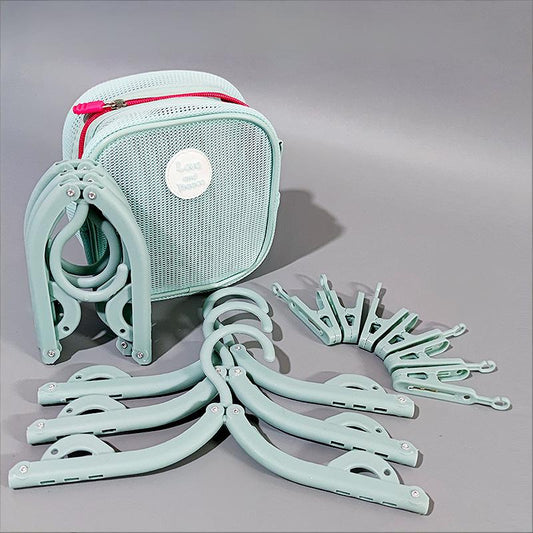 Set of light blue hangers and a matching carrying case on a gray background