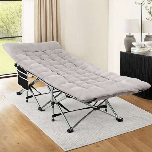 Gray folding bed in a room with a desk and lamp