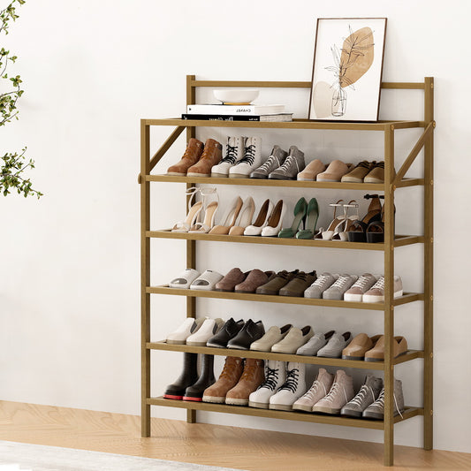 Wooden shoe rack with various shoes on a white wall background