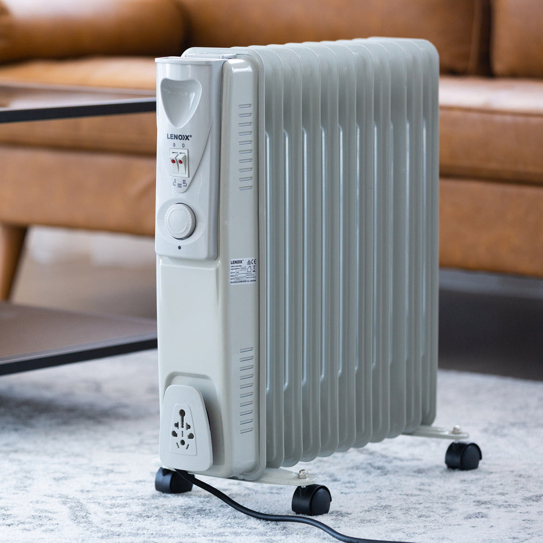 Portable electric heater in a living room setting with a couch and coffee table.