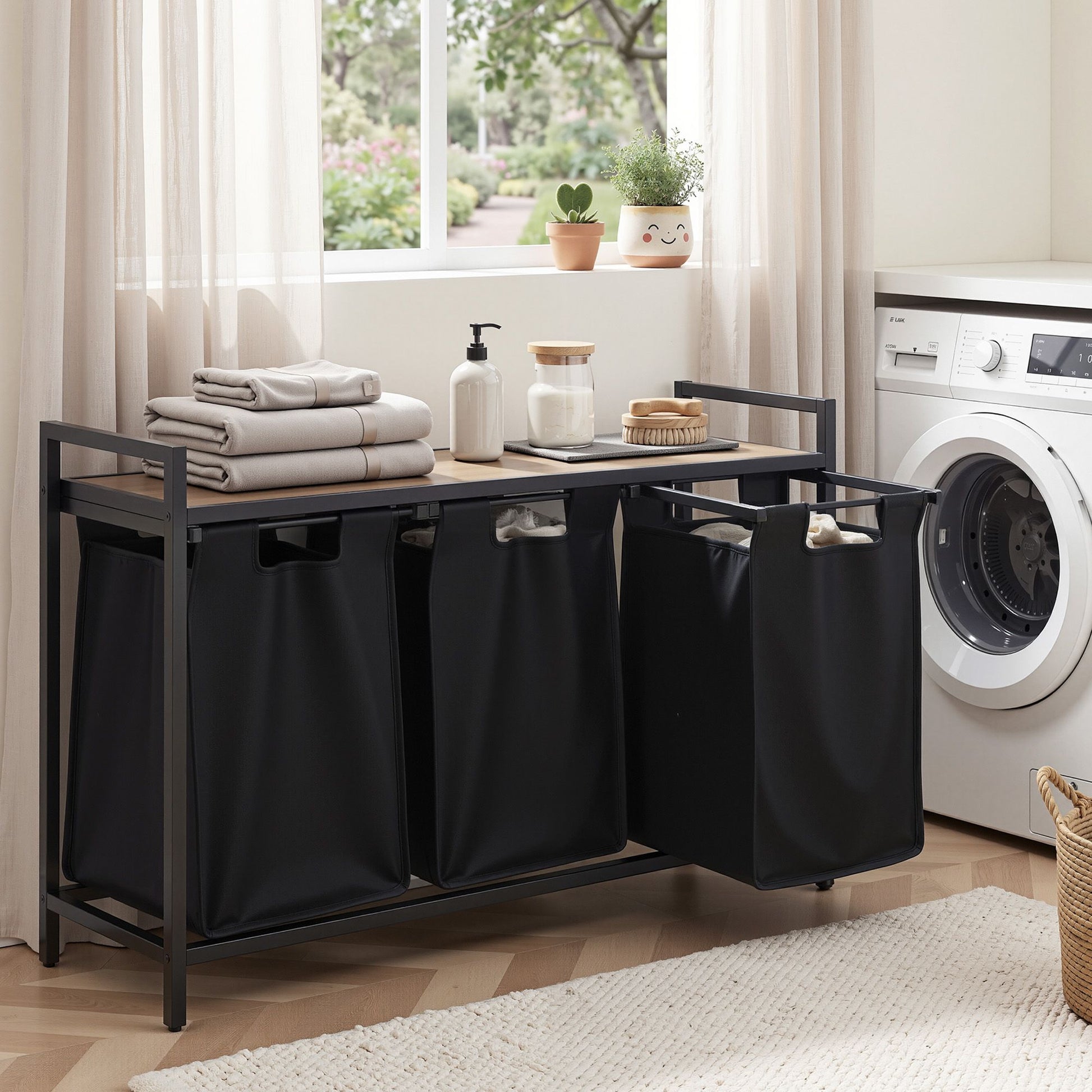 Laundry sorting station with three black bags in a laundry room.