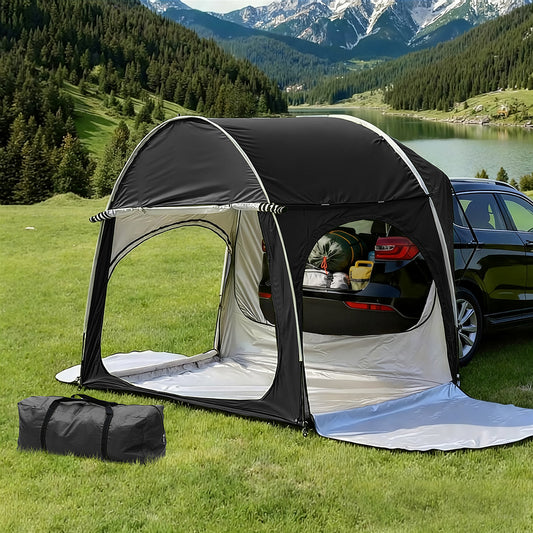 Car tent set up next to a car in a scenic outdoor setting with mountains and a lake.