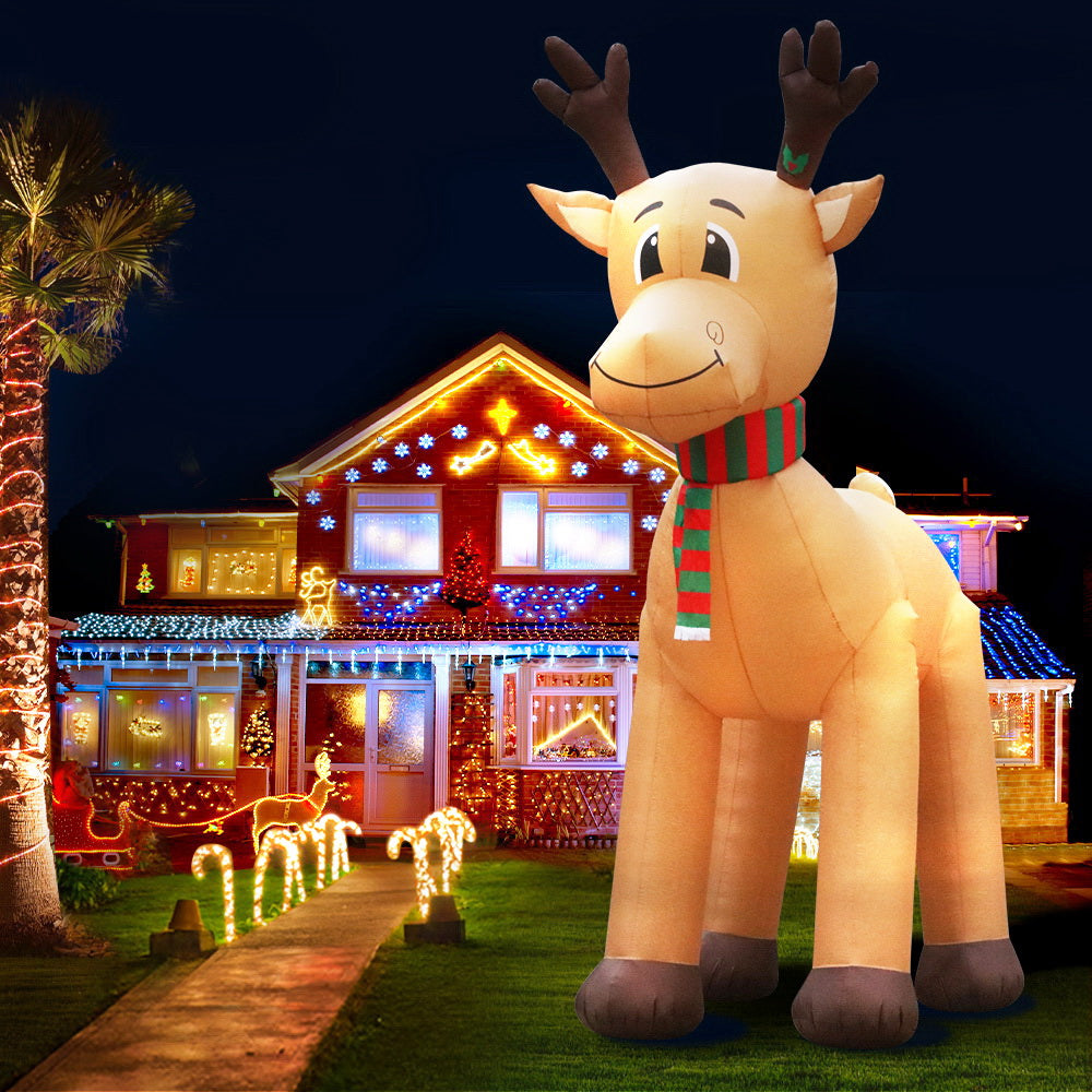 Inflatable reindeer decoration in front of a house with Christmas lights
