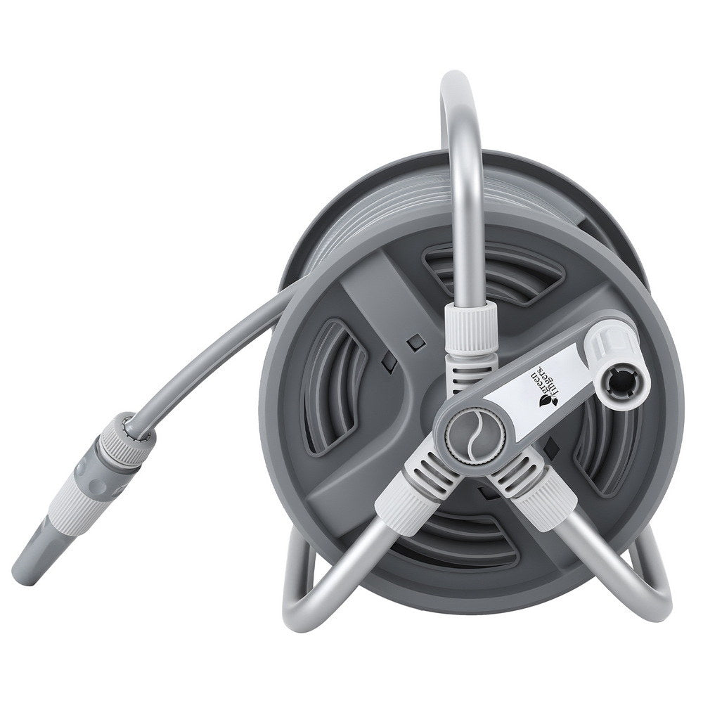 Retractable hose reel with the hose extended across a garden