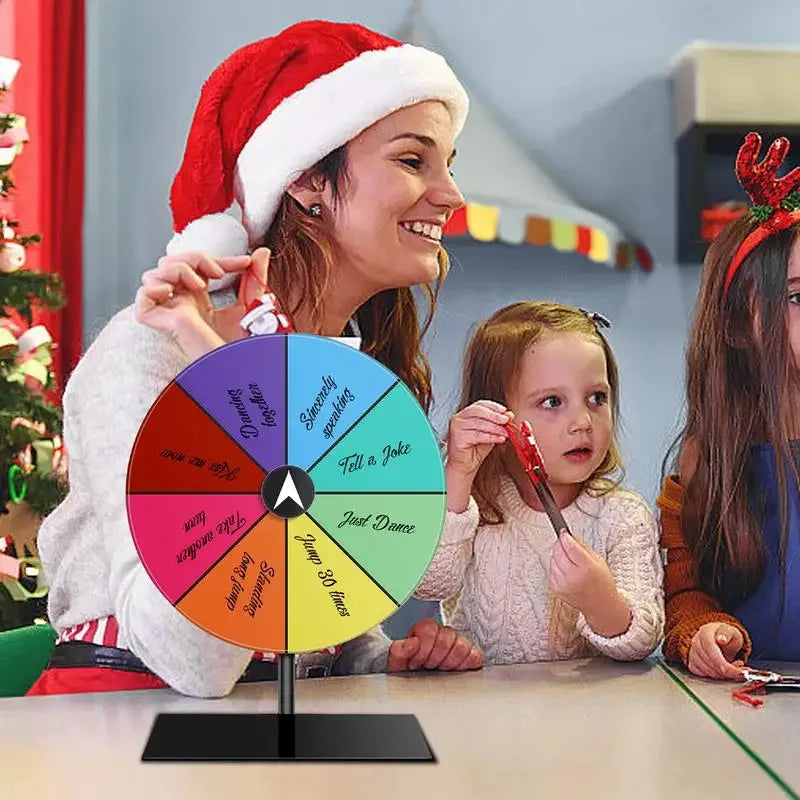 Woman and children playing with a colorful wheel of fortune in a festive setting.
