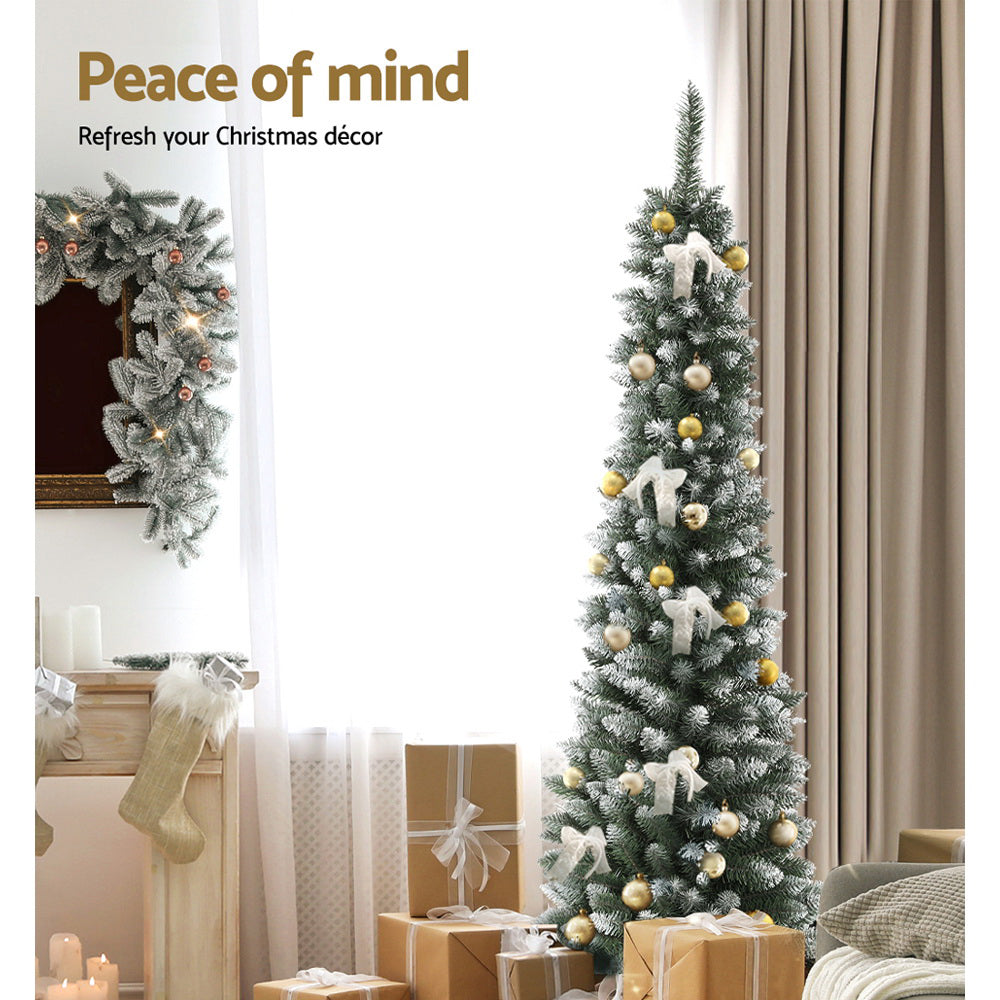 Snow flocked tree decorated with ornaments