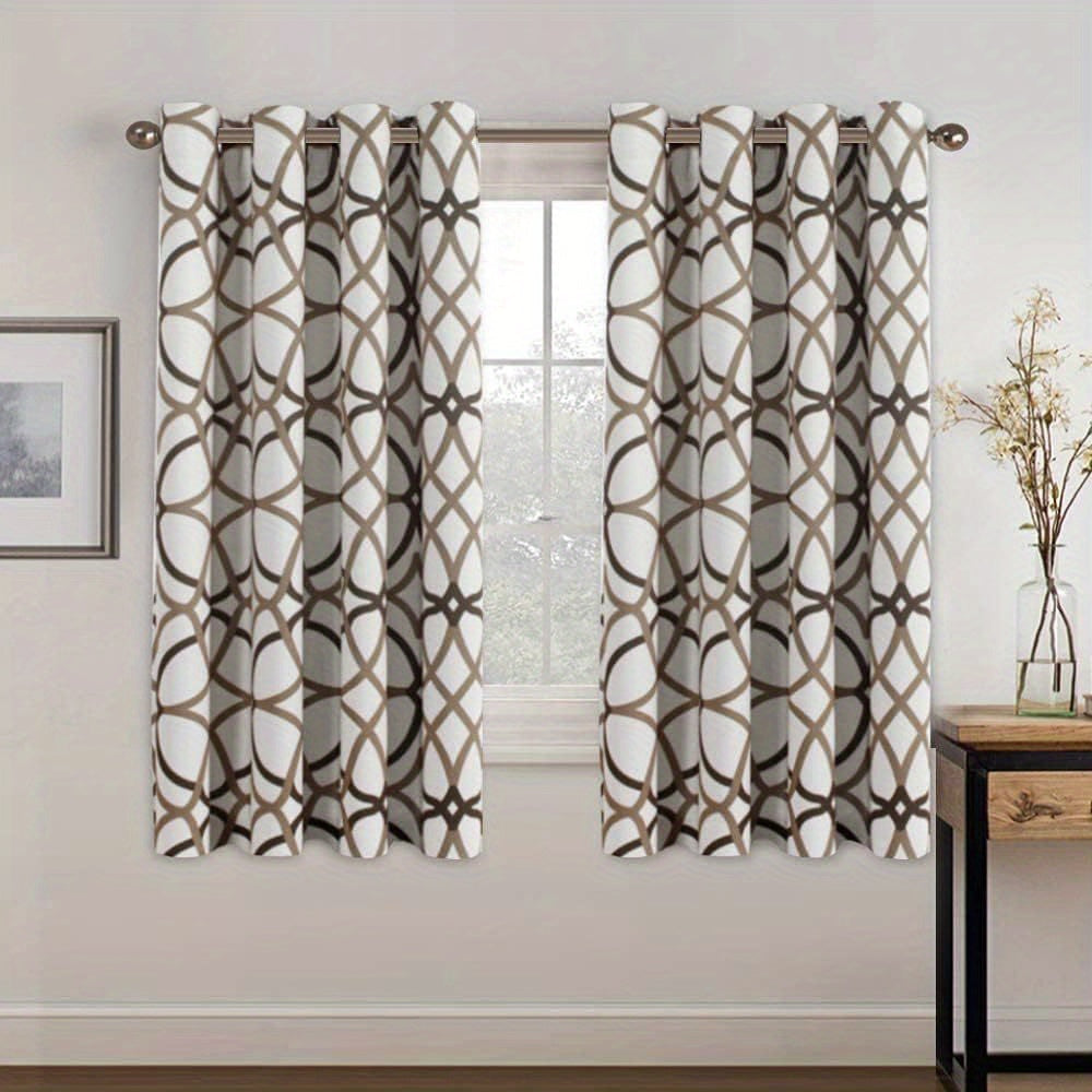 Printed blackout curtains draped at a window