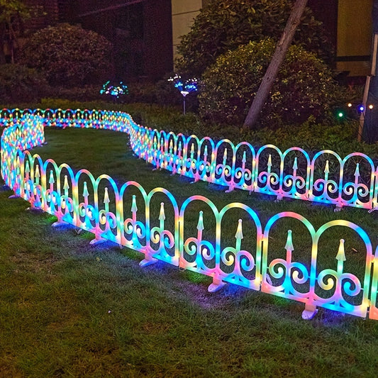 Solar fence lights glowing warm white at night